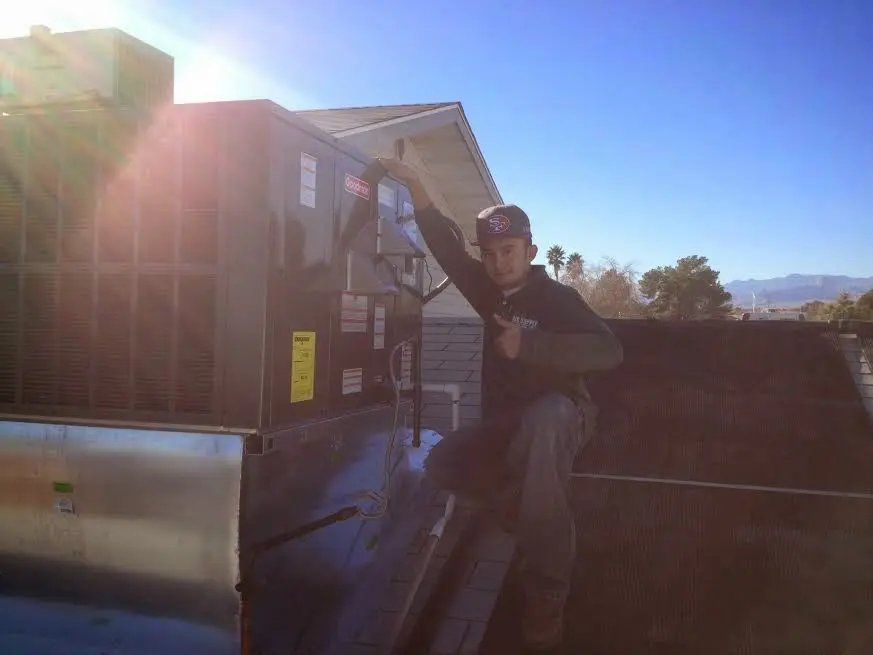 HVAC technician performing HVAC Inspection on a rooftop unit in South Windsor